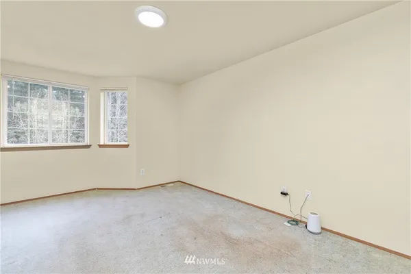 an empty room with a empty space and windows