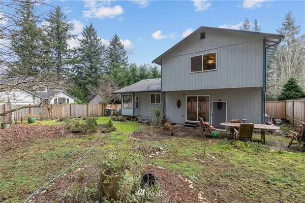 a front view of a house with garden and patio