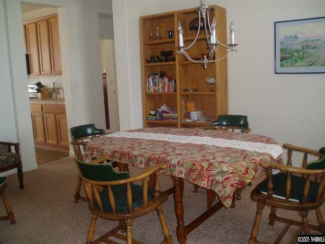 10645 Copper Lake Drive Reno, NV 89521 - Photo 4 of 8 a room with table chairs and wooden floor