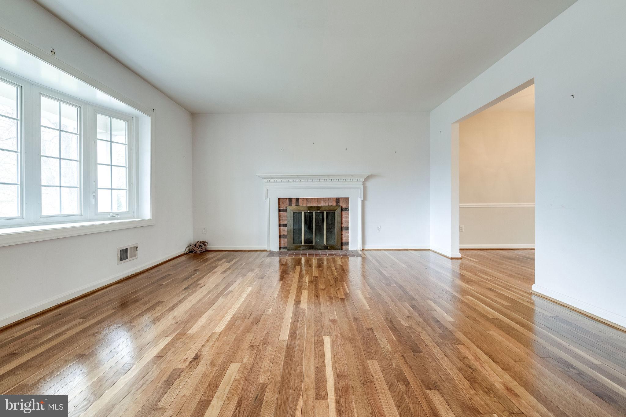 7723 Hayfield Road Alexandria, VA 22315 - Photo 4 of 28 Spacious living room with wood burning fireplace
