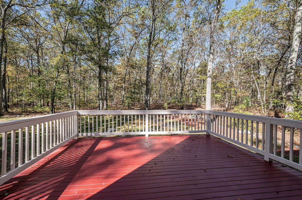 38 Pine Ridge Drive Ayer, MA 01432 - Photo 11 of 42 a view of deck with wooden floor and fence