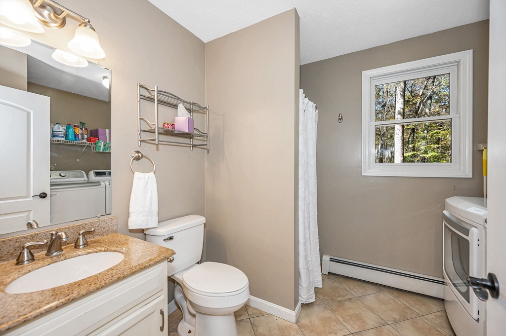 38 Pine Ridge Drive Ayer, MA 01432 - Photo 12 of 42 a bathroom with a granite countertop sink mirror vanity and toilet