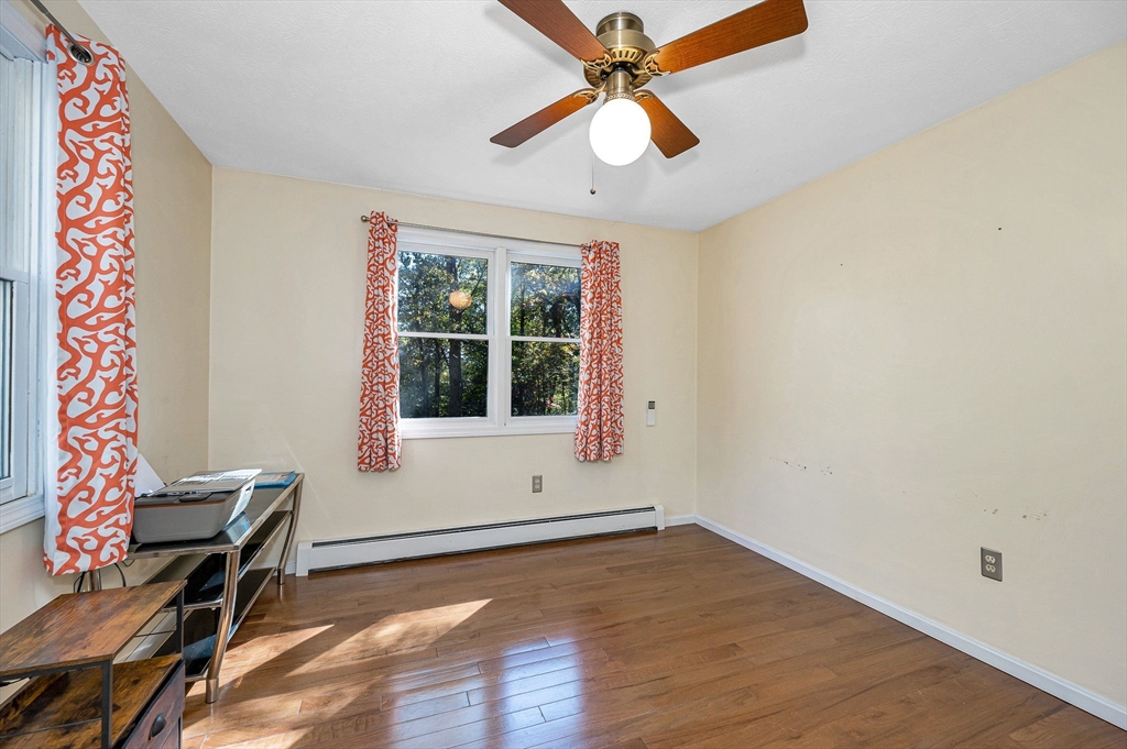 38 Pine Ridge Drive Ayer, MA 01432 - Photo 14 of 42 an empty room with wooden floor fan and windows