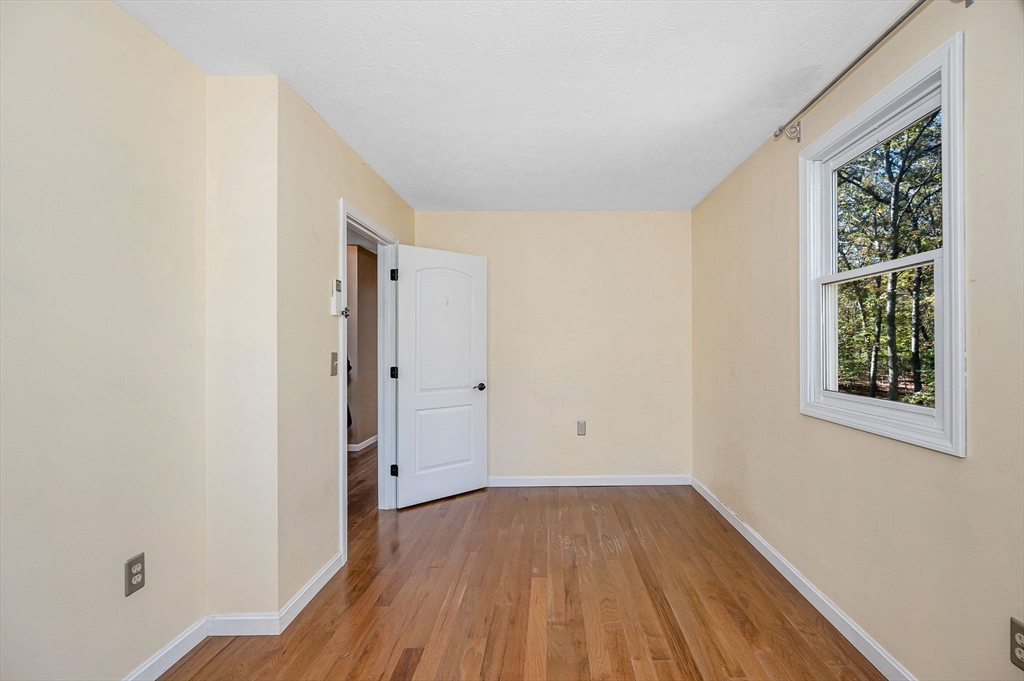 38 Pine Ridge Drive Ayer, MA 01432 - Photo 20 of 42 a view of a room with wooden floor and window