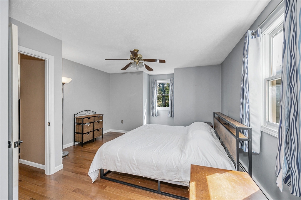 38 Pine Ridge Drive Ayer, MA 01432 - Photo 23 of 42 a bedroom with a bed and wooden floor