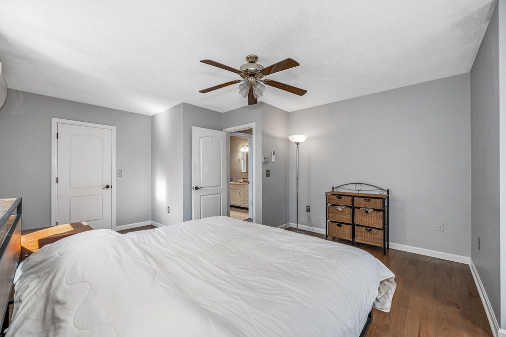 38 Pine Ridge Drive Ayer, MA 01432 - Photo 24 of 42 a bedroom with a bed and a chandelier