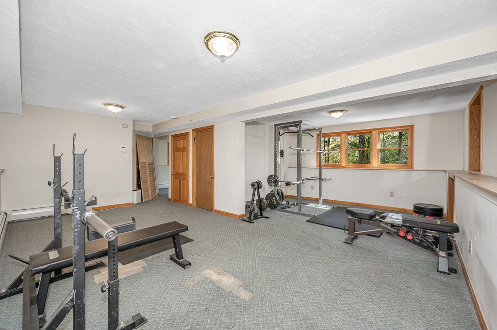 38 Pine Ridge Drive Ayer, MA 01432 - Photo 26 of 42 a room with gym equipment and a large window