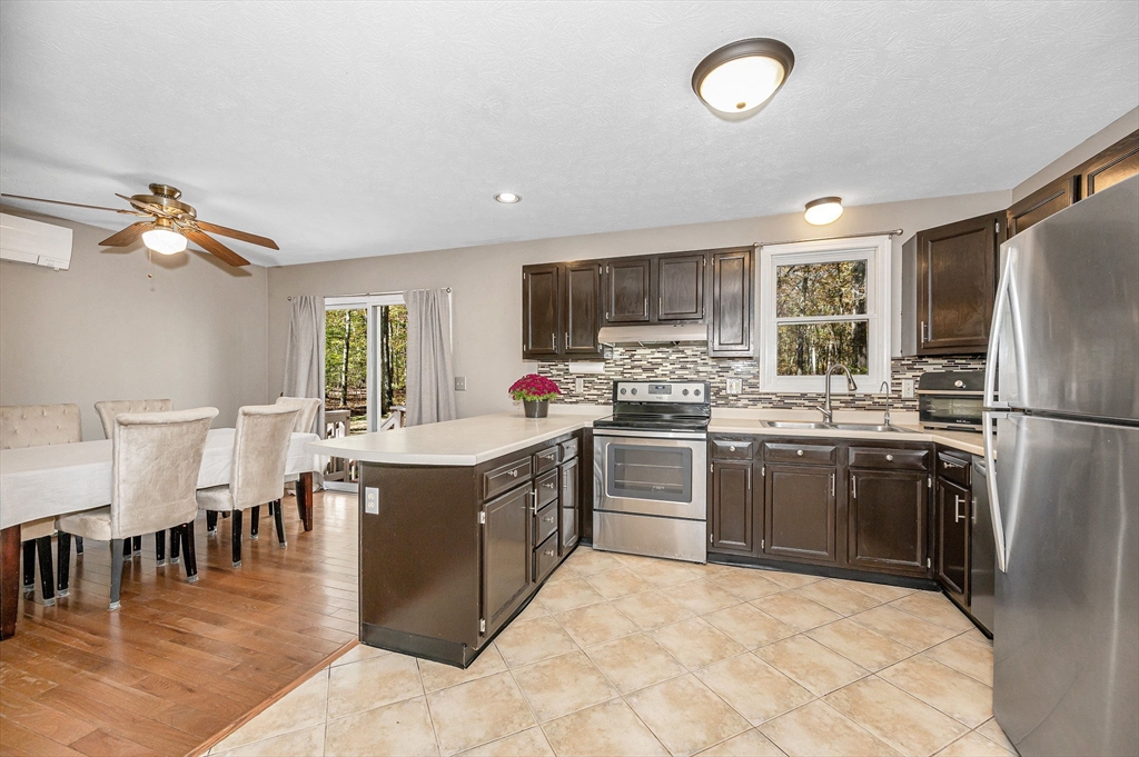 38 Pine Ridge Drive Ayer, MA 01432 - Photo 3 of 42 a large kitchen with cabinets stainless steel appliances a sink and a dining table view