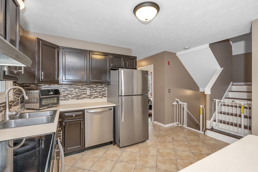 38 Pine Ridge Drive Ayer, MA 01432 - Photo 5 of 42 a kitchen with stainless steel appliances granite countertop a refrigerator sink and stove