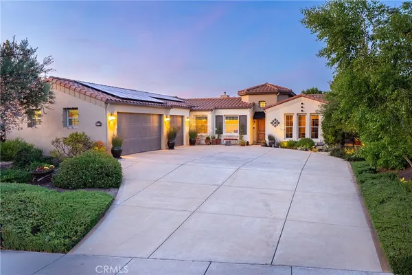 a front view of a house with yard and green space
