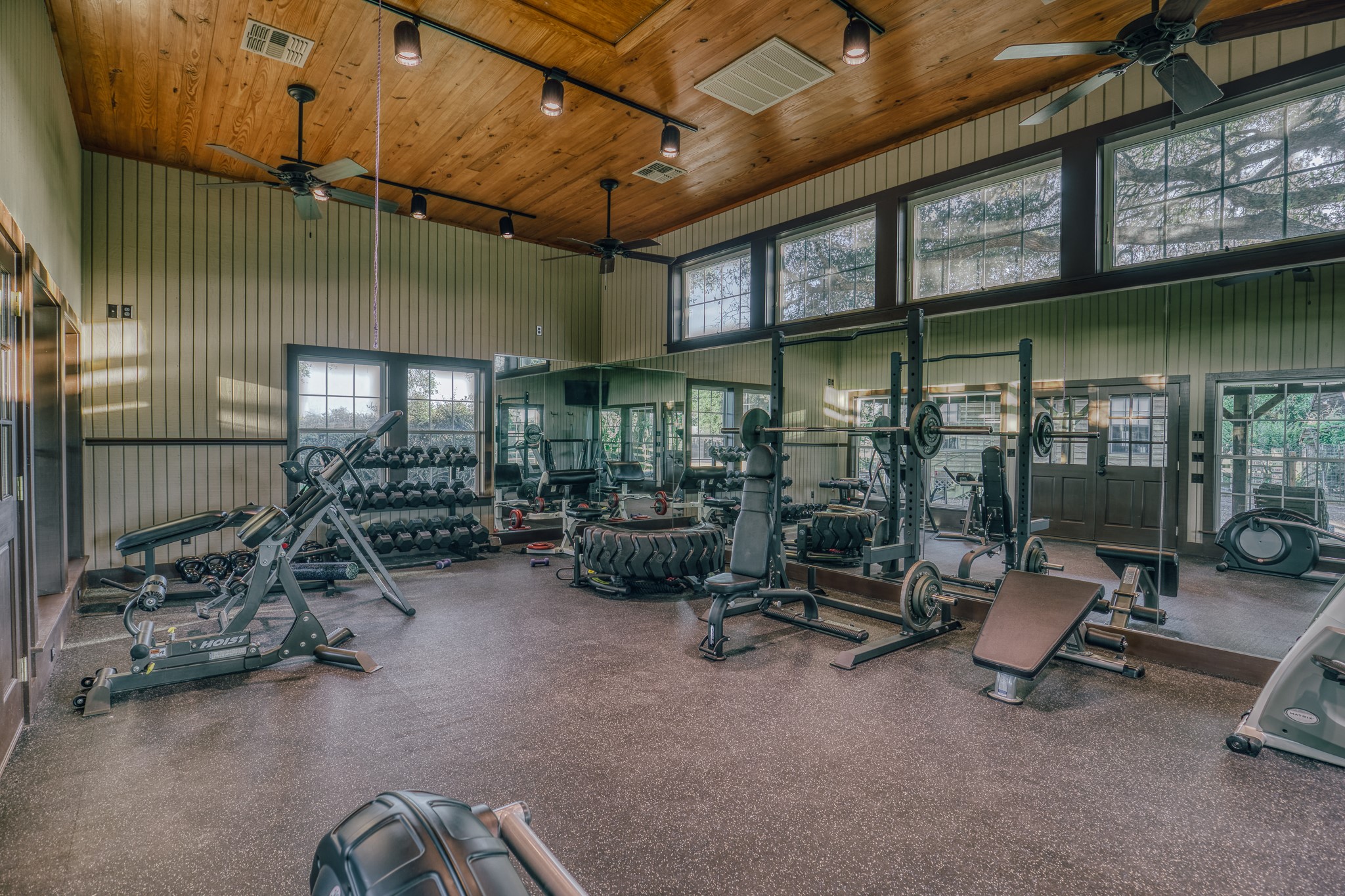 1034 Hilbun Road New Ulm, TX 78950 - Photo 43 of 49 Beautifully designed gym with vaulted ceilings, extensive mirrors, and a bright, open layout creating an exceptional fitness retreat.