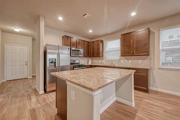 a kitchen with a sink stove and refrigerator