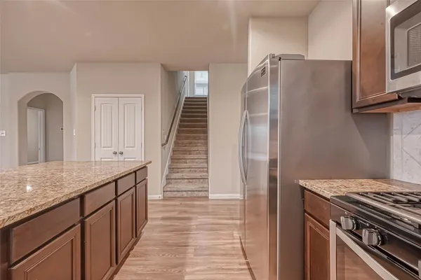 a kitchen with a sink a counter top space and cabinets