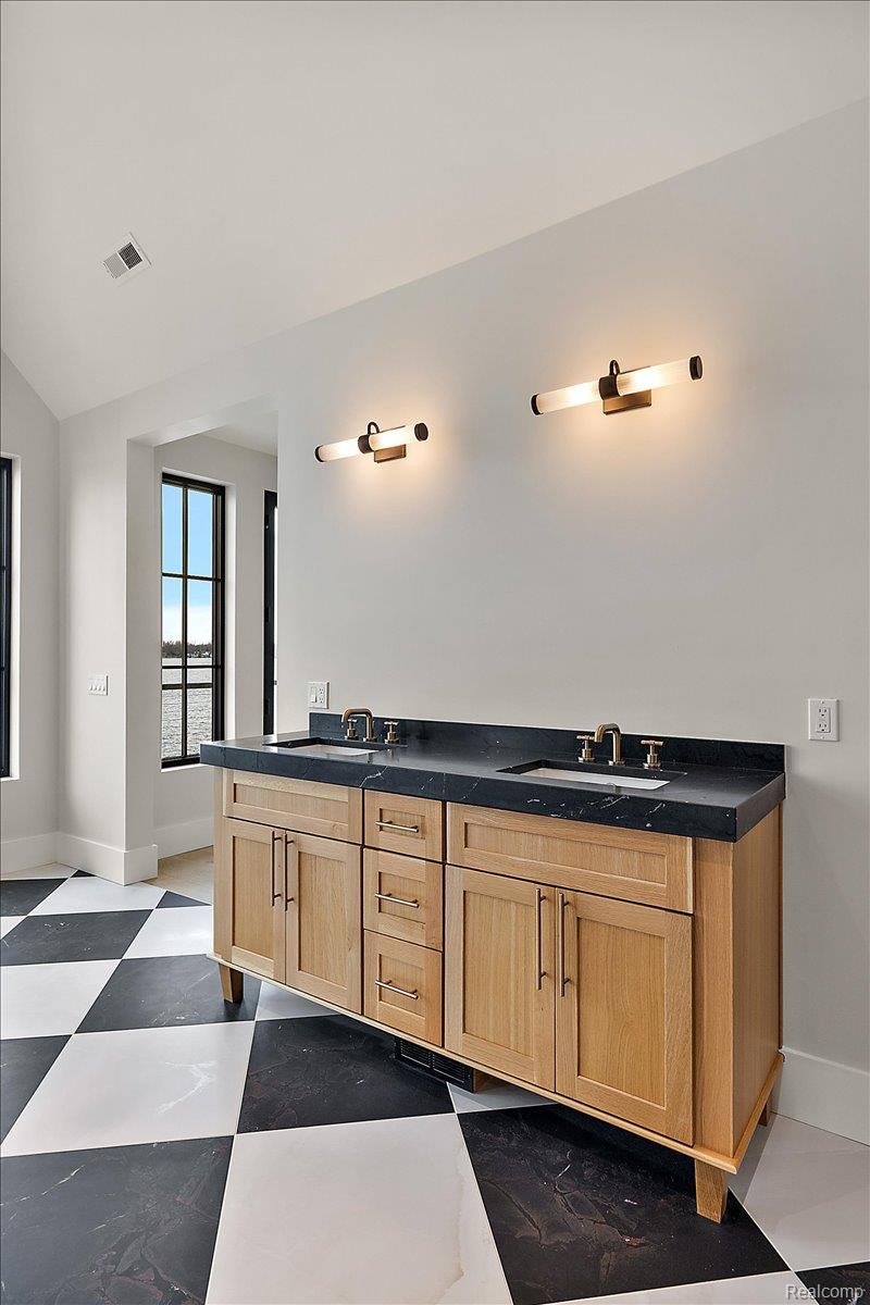 13459 Haddon Street Fenton, MI 48430 - Photo 42 of 84 Bathroom featuring double vanity, lofted ceiling, and dark flooring