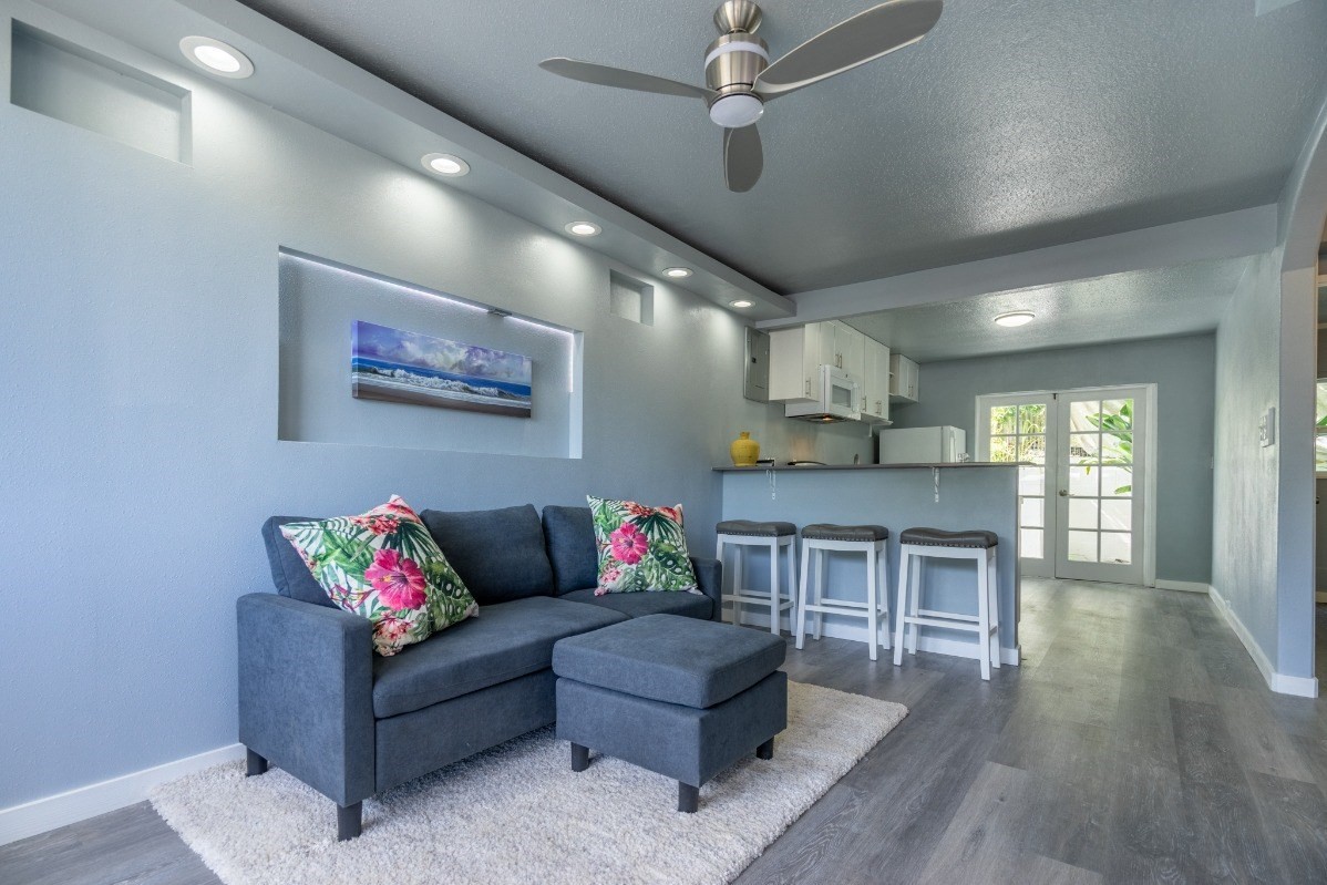 a living room with furniture and kitchen view