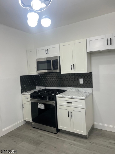925 South Street Elizabeth, NJ 07202 - Photo 2 of 7 a stove top oven sitting inside of a kitchen