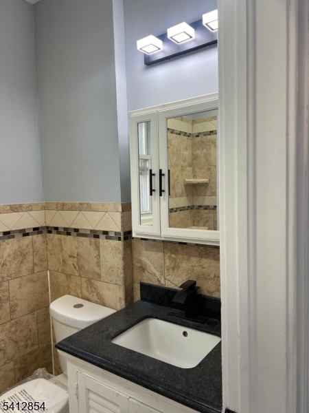 925 South Street Elizabeth, NJ 07202 - Photo 5 of 7 a bathroom with a granite countertop sink mirror vanity and toilet