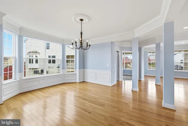 a view of an empty room with fireplace and a window