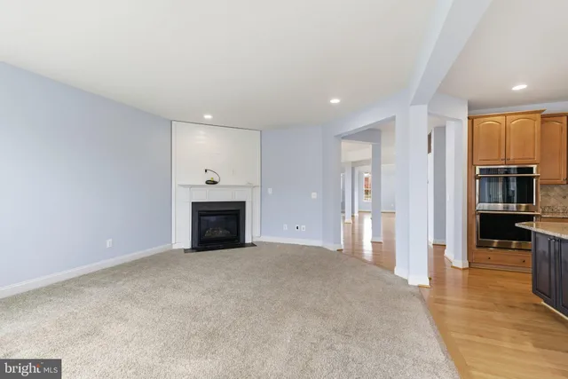 a kitchen with granite countertop sink stove and cabinets