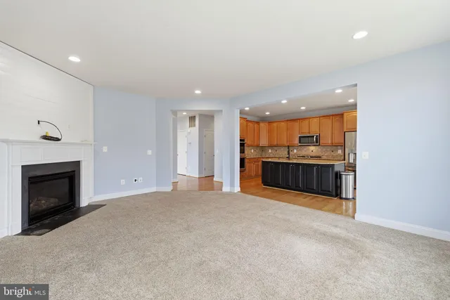 a kitchen with stainless steel appliances granite countertop a refrigerator a sink and a stove