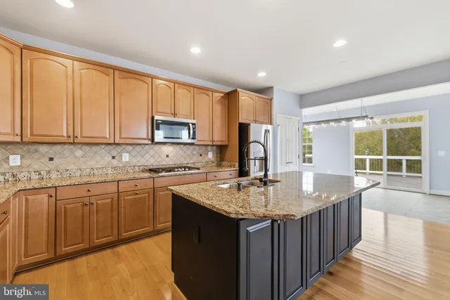 a kitchen that has a sink and a granite counter top