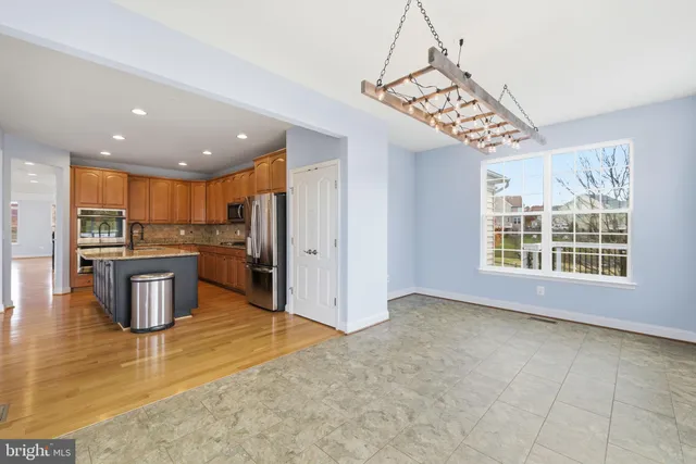 an empty room with a window and a ceiling fan