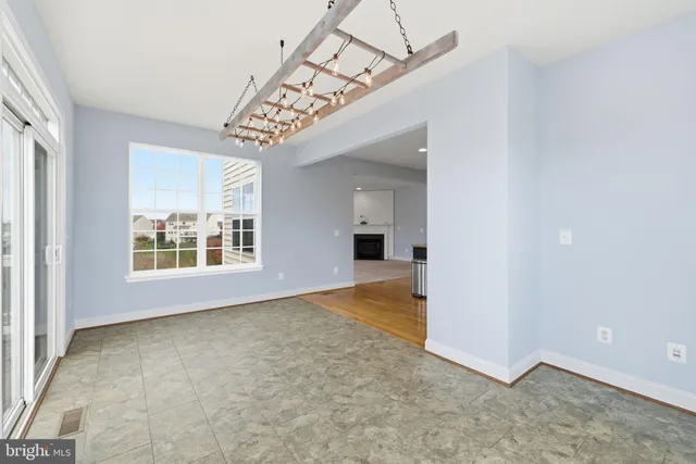an empty room with a ceiling fan and a window