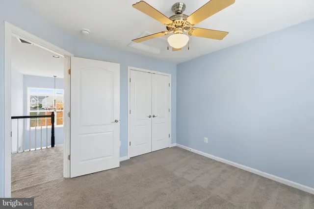 a bathroom with a granite countertop sink toilet a mirror and shower