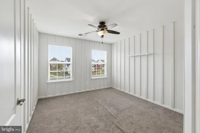 a view of a livingroom with a chandelier fan