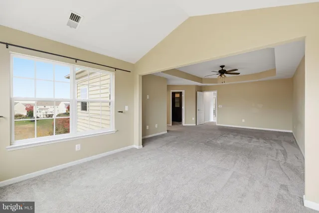 a spacious bathroom with a tub a sink double vanity and a mirror