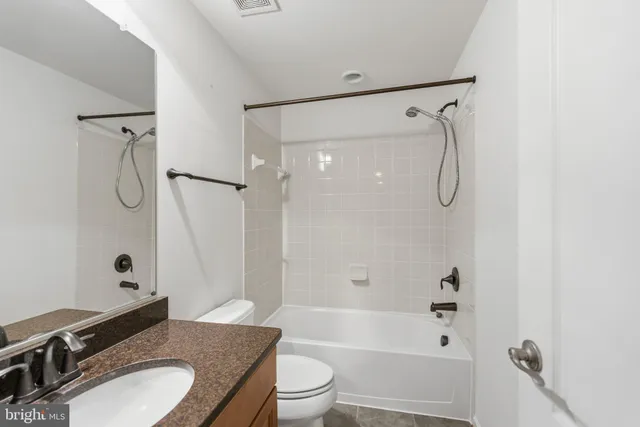 a view of a white house with a big yard and large trees