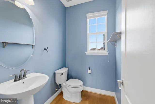 a view of a livingroom with wooden floor and staircase