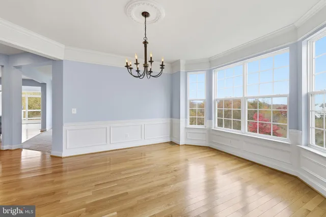 a view of a livingroom with wooden floor and staircase