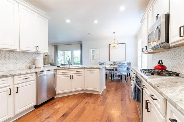 a kitchen with a sink cabinets and wooden floor