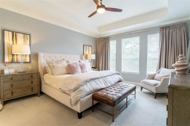 a bedroom with bed couch and window