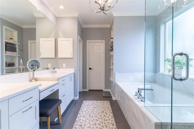 a spacious bathroom with a tub sink and mirror