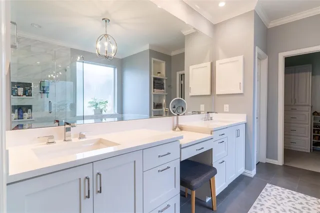 a bathroom with double vanity and a mirror