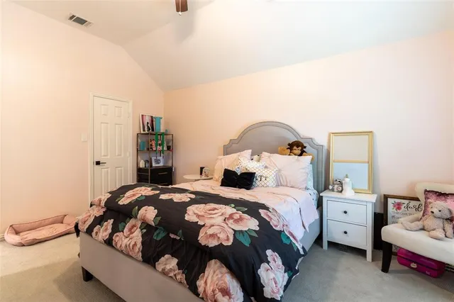 a bedroom with a bed and a couch