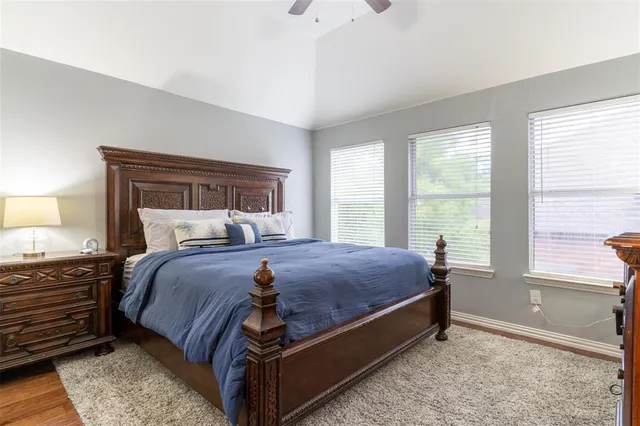 a bed sitting in a bedroom next to a window