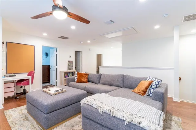 a living room with furniture and a lamp