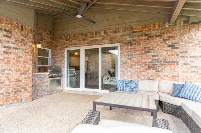 a view of a patio with couches table and chairs and potted plants