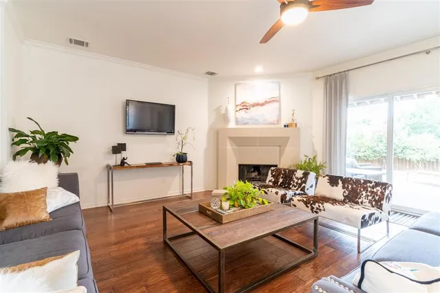 a living room with fireplace furniture and a flat screen tv
