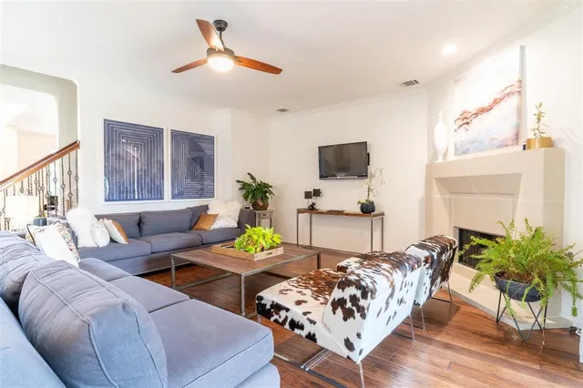 a living room with furniture potted plant and a flat screen tv