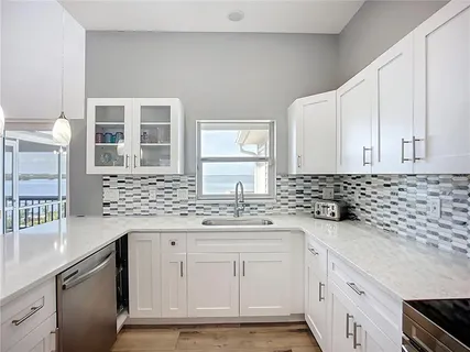 a bathroom with a granite countertop sink a toilet and a mirror