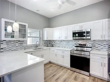 a utility room with sink dryer and washer
