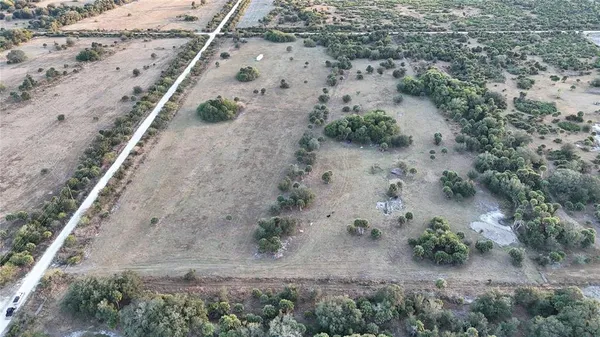 an aerial view of house with a yard