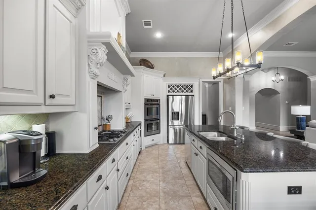 a large kitchen with granite countertop a lot of counter space