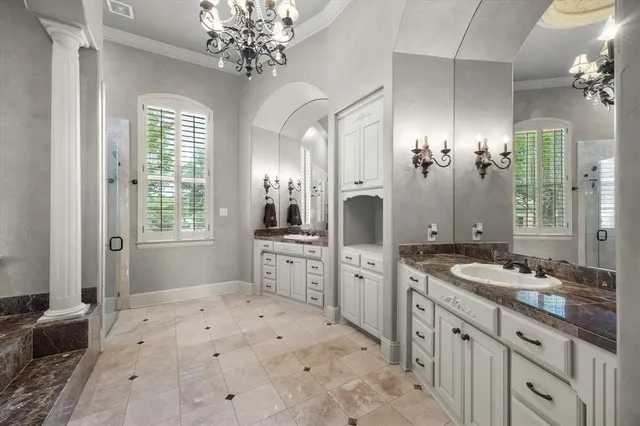 a spacious bathroom with a granite countertop sink a large mirror a shower and a bathtub