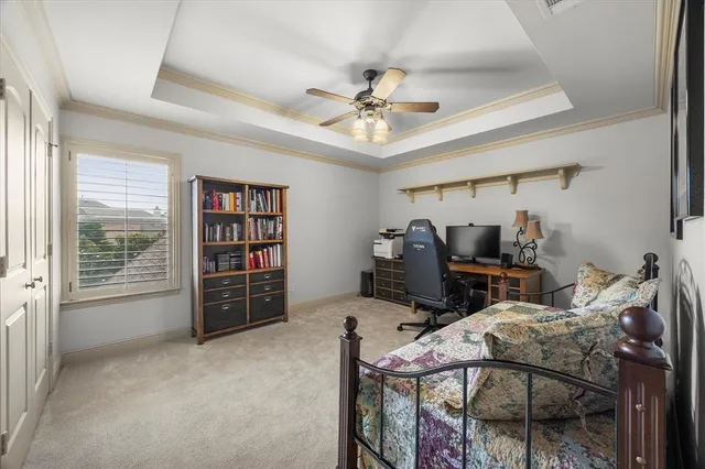 a view of a workspace with furniture and a window