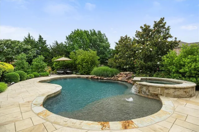 a view of a swimming pool with an outdoor space and seating area